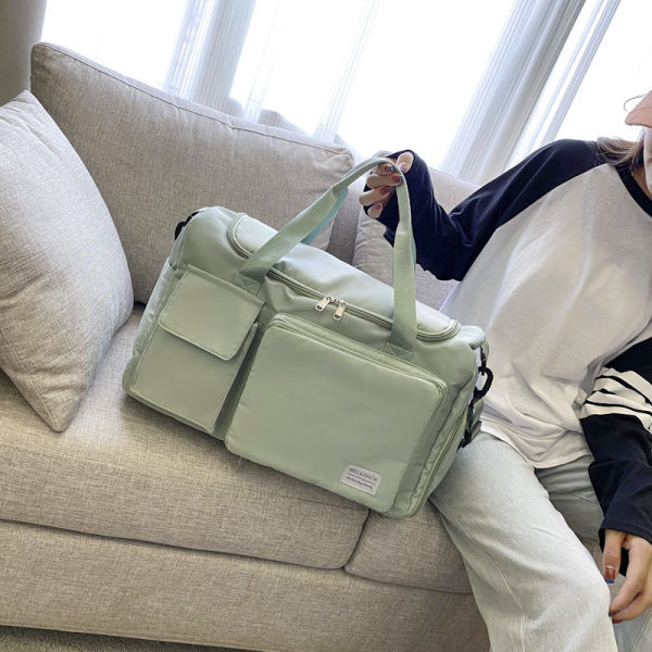 Tekstila soma ar priekšējām kabatām un garu rokturi