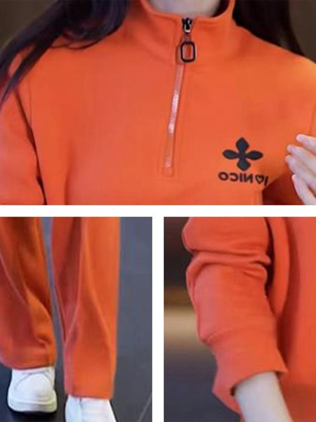 Sportisks divdaļīgs komplekts ar rāvējslēdzēja augšdaļu un izšuvumu un apakšā ar kabatu