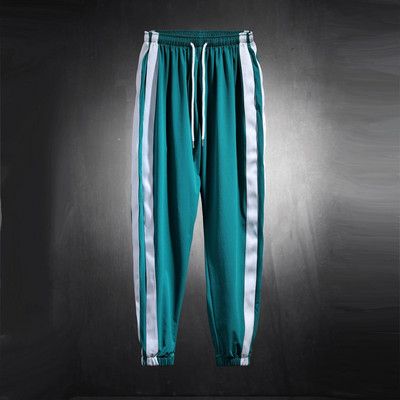 Vīriešu sporta bikšu plats modelis ar apmalīti