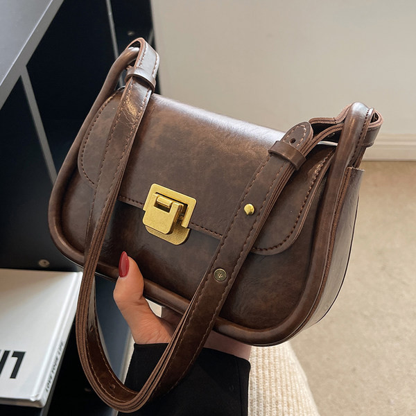 Négyzet alakú kis táska vállfogantyúval