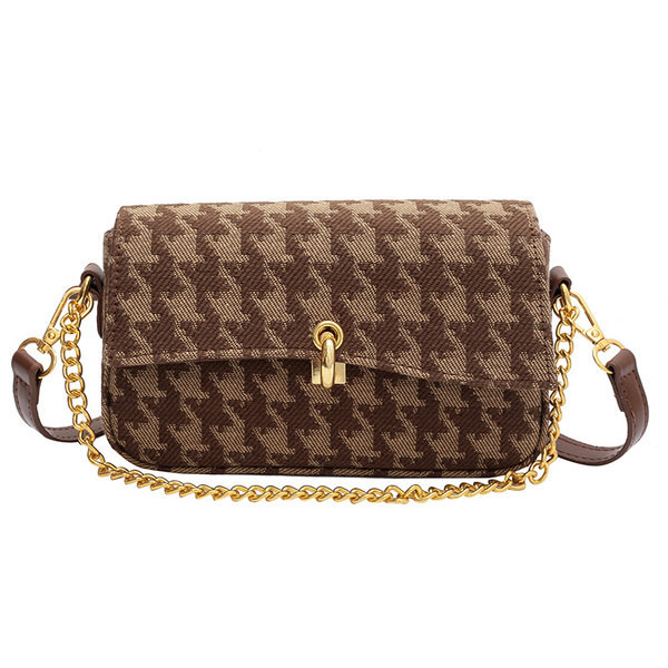 Ženska tekstilna torba sa metalnim elementima