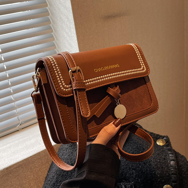 Kézitáska fém medállal és felirattal