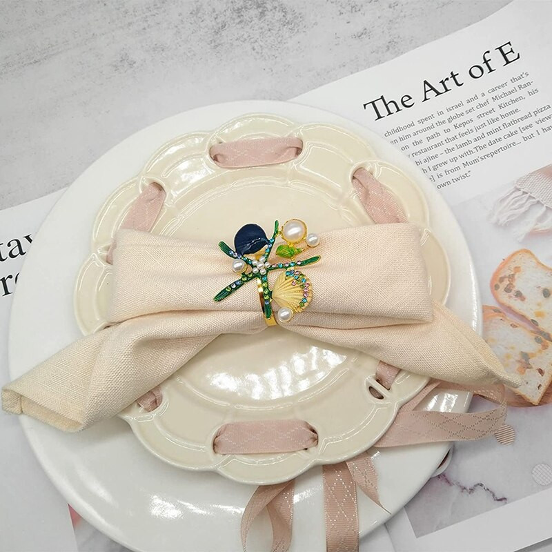 6 tk meritähe salvrätikurõngaid, pärlikivist ookeani merendussalvrätikuhoidjad pulmapeo jaoks, lauakaunistused jne