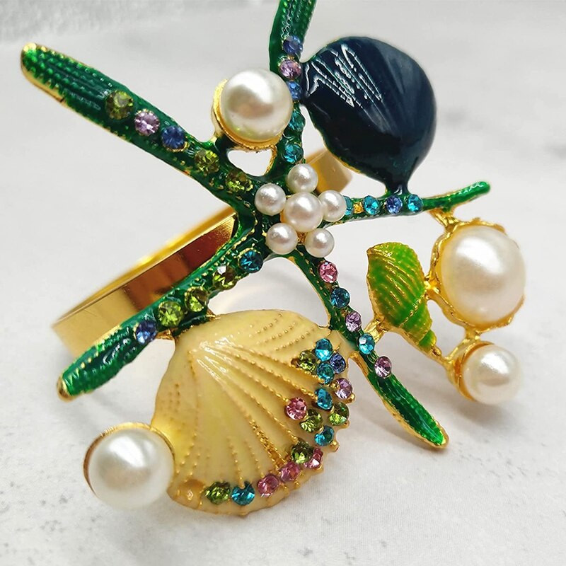 6 tk meritähe salvrätikurõngaid, pärlikivist ookeani merendussalvrätikuhoidjad pulmapeo jaoks, lauakaunistused jne