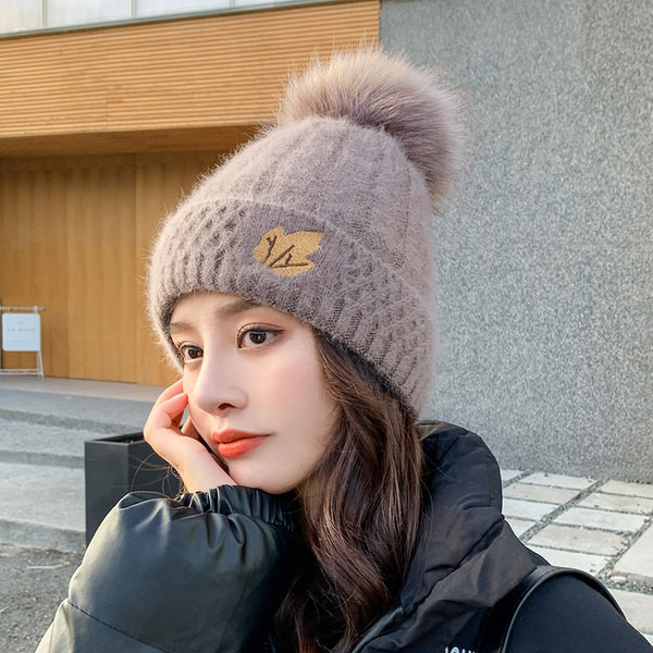 Naiste kootud müts tikandi ja pommiga