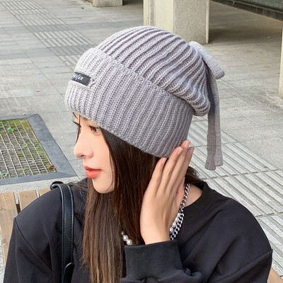 Γυναικείο χειμωνιάτικο πλεκτό καπέλο με γράμματα και κορδόνια