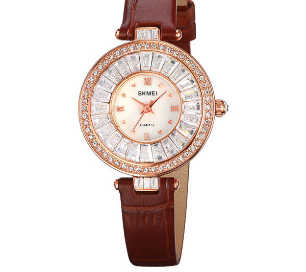 Ümara kuju ja kivikestega naiste käekell