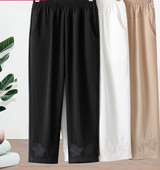 Stiilsed naiste püksid tikandite ja taskutega