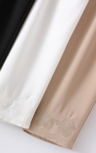 Stiilsed naiste püksid tikandite ja taskutega