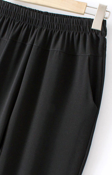 Stiilsed naiste püksid tikandite ja taskutega