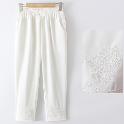 Stiilsed naiste püksid tikandite ja taskutega