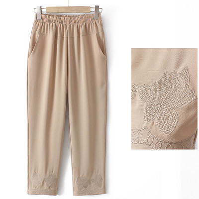 Stiilsed naiste püksid tikandite ja taskutega