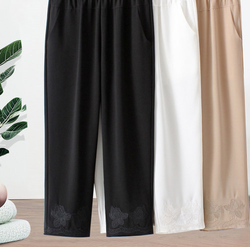 Stiilsed naiste püksid tikandite ja taskutega