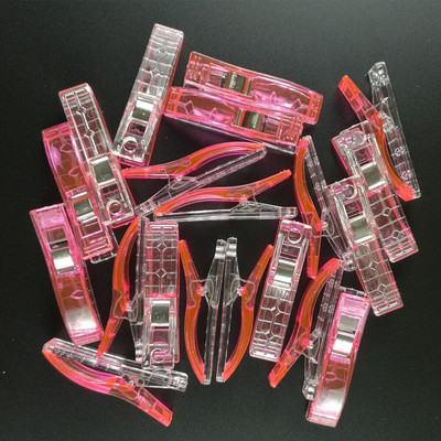 100 vnt. plastikinių audinių segtukai, spaustukai, skirti amatų siuvimui.