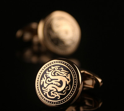 Men`s cufflinks in gold color with engraved dragon