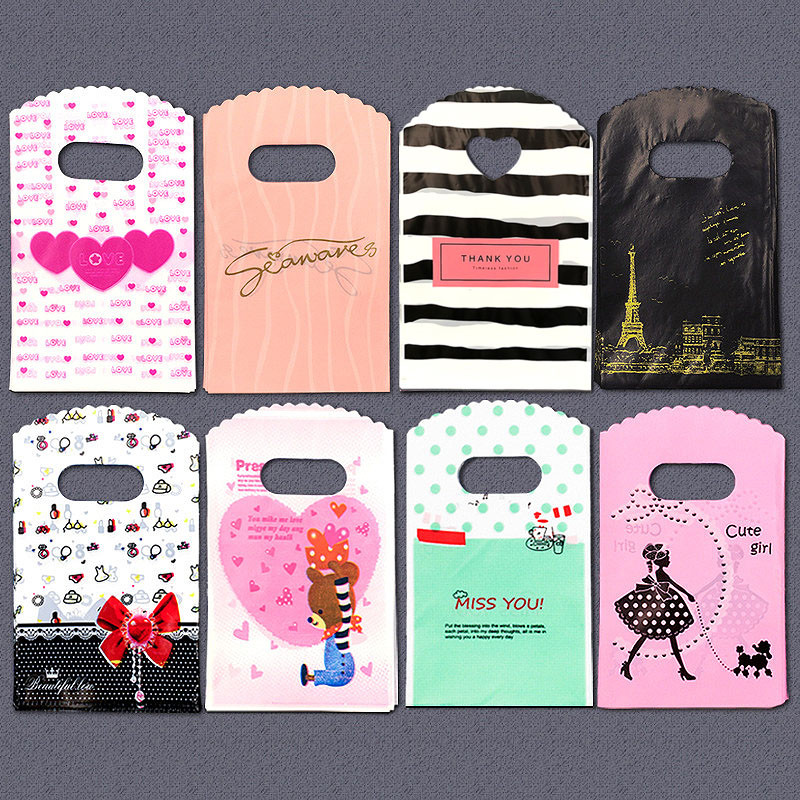 50 τμχ/παρτίδα Διάφορα μοτίβα κοσμήματα Πλαστική τσάντα σε σχήμα καρδιάς Οβάλ λαβές Μίνι τσάντα συσκευασίας δώρου Κατάστημα μικρές τσάντες αγορών