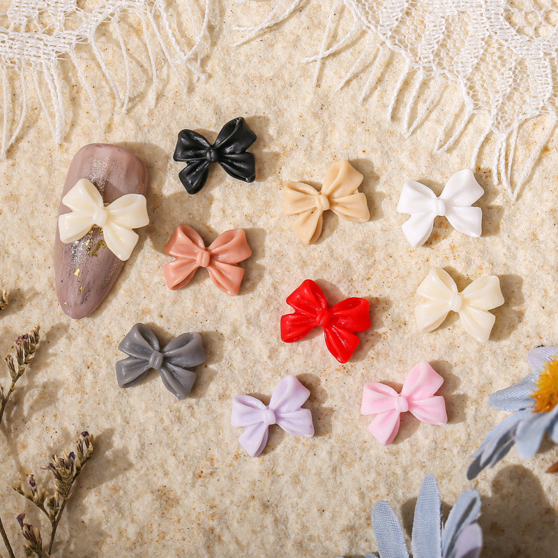 50db Kawaii Bow Resin Nail Art Charm 3D Bowknot Nyári Aranyos Dísz Ékszer Craft Csokornyakkendő Dekorációs Alkatrészek Manikűr 8,5*12,5mm