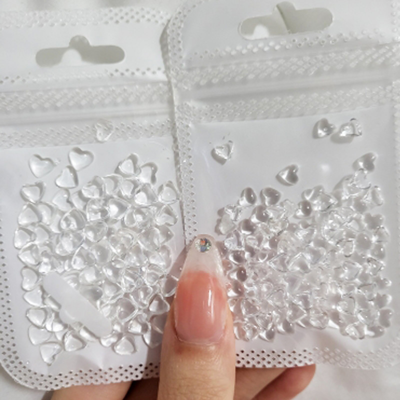 100 vnt Clear Love Heart Nail Art Charms Skaidrūs krištolo dervos nagų dekorai Želė Kalnų krištolo skaistalų efekto papuošalai manikiūrui
