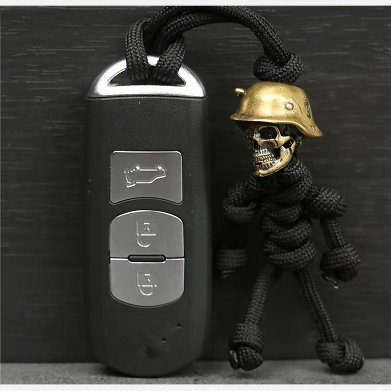 1PC Glava lubanje Privjesak za ključeve Auto Bikerska kaciga Privjesak Privjesak za ključeve Pleteni konop Paracord Buddy Bag Viseći ruksak Lutka