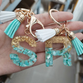 Brelocuri cu litere din rășină 26 de inițiale cu breloc din folie de aur Pandantiv de geantă pentru femei Brelocuri cu ciucuri cu alfabet Accesorii Cadouri