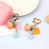 Slatke stereo breskve privjesci za slušalice od legure Heat-shaper privjesak za ključeve šarene kuglice ukrasi torba privjesak za ključeve kreativni privjesci za ključeve darovi