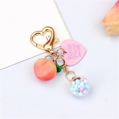 Slatke stereo breskve privjesci za slušalice od legure Heat-shaper privjesak za ključeve šarene kuglice ukrasi torba privjesak za ključeve kreativni privjesci za ključeve darovi