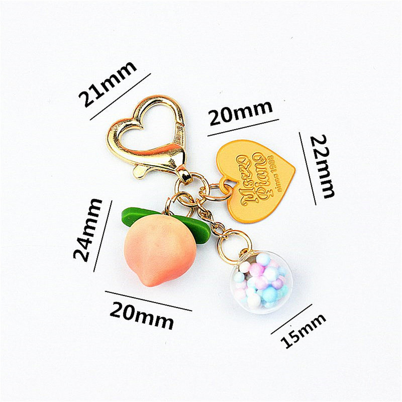 Slatke stereo breskve privjesci za slušalice od legure Heat-shaper privjesak za ključeve šarene kuglice ukrasi torba privjesak za ključeve kreativni privjesci za ključeve darovi