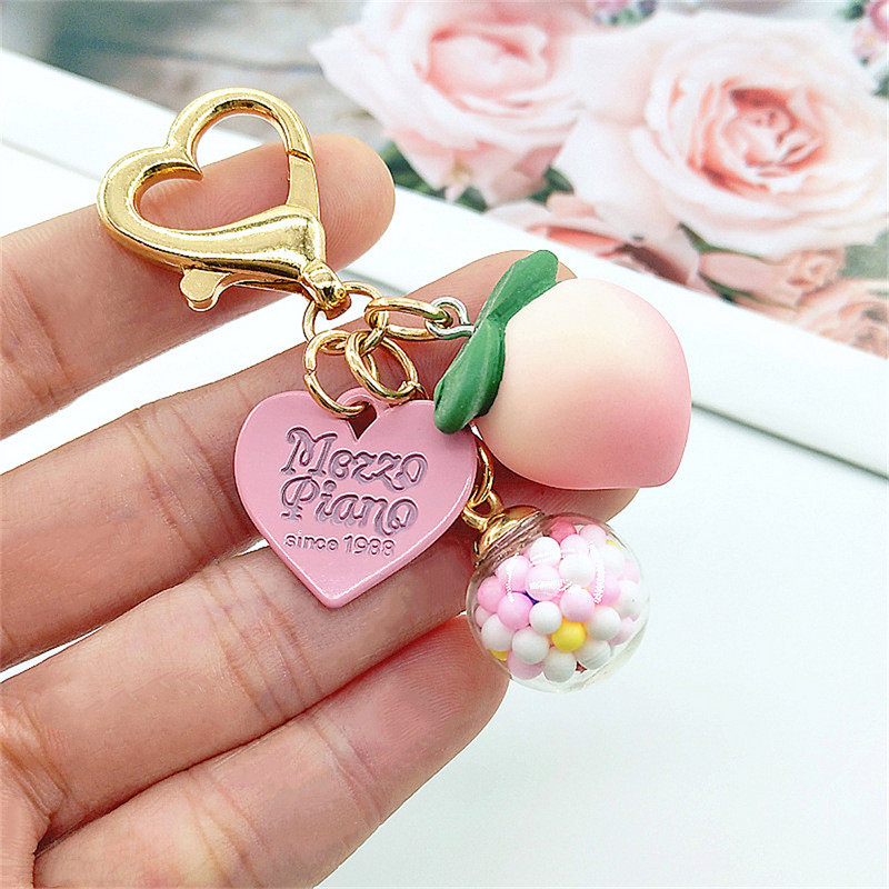 Slatke stereo breskve privjesci za slušalice od legure Heat-shaper privjesak za ključeve šarene kuglice ukrasi torba privjesak za ključeve kreativni privjesci za ključeve darovi