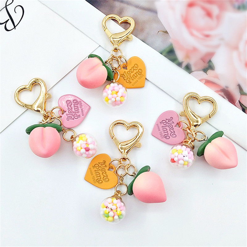 Slatke stereo breskve privjesci za slušalice od legure Heat-shaper privjesak za ključeve šarene kuglice ukrasi torba privjesak za ključeve kreativni privjesci za ključeve darovi