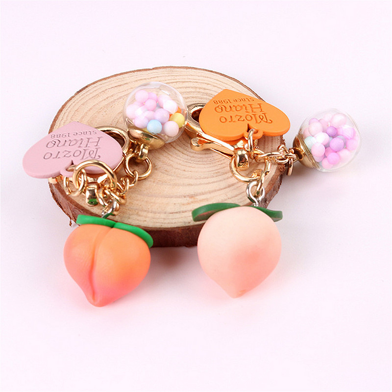 Slatke stereo breskve privjesci za slušalice od legure Heat-shaper privjesak za ključeve šarene kuglice ukrasi torba privjesak za ključeve kreativni privjesci za ključeve darovi