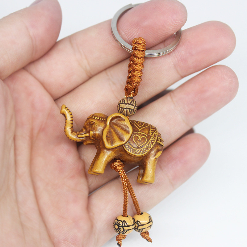 Állati elefánt kulcstartó őszibarack fafaragás Rich Lucky Animal kulcstartó medál női táskák Pom Pom Charm otthoni kulcstartók 1-3db