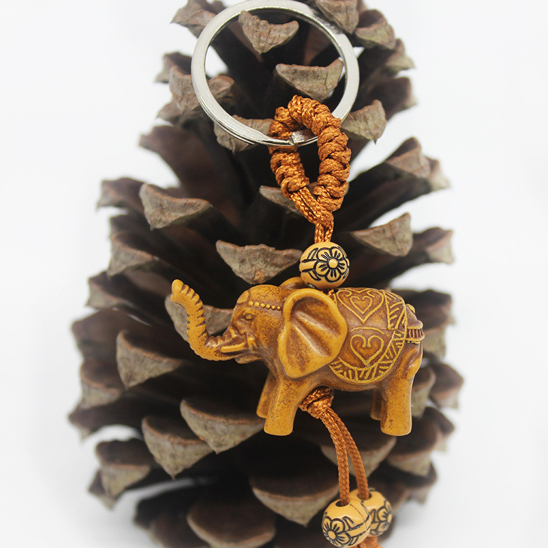 Állati elefánt kulcstartó őszibarack fafaragás Rich Lucky Animal kulcstartó medál női táskák Pom Pom Charm otthoni kulcstartók 1-3db
