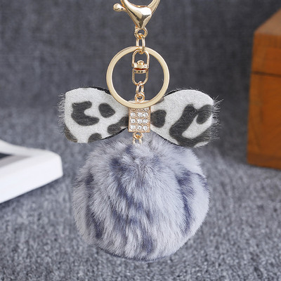 Leopárdmintás masnis plüss kulcstartó női trendi nyúlszőrme golyós kulcstartó Női táska medál ékszer kiegészítők karácsonyi ajándékok
