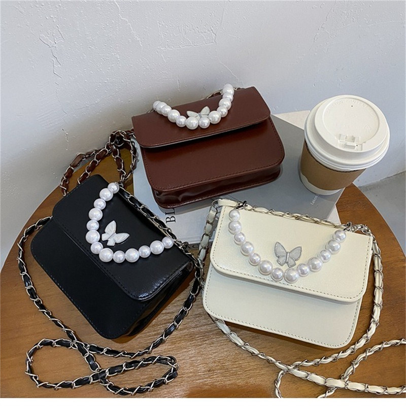 Klassikalised ühevärvilised PU õlakotid Naistele Pearl Butterfly käekotid Kandid naistele vabaaja reisimiseks Crossbody slingi kott