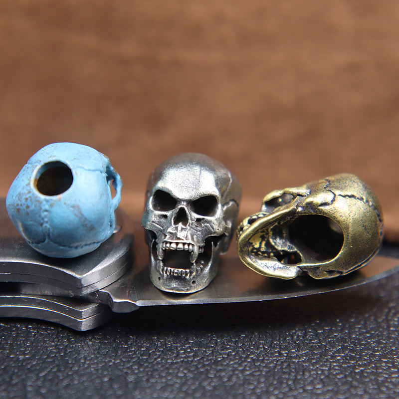 Karmid hambad Koljupea Messingist Paracord Helmed Paelad Ripatsid DIY EDC Välistööriist Vihmavarjunöör kootud nugade amuletid Aksessuaarid