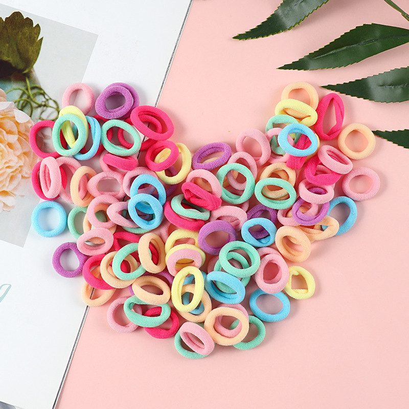 100 τμχ Παιδικό μικρό δαχτυλίδι μαλλιών για κορίτσια Χαριτωμένα γλυκά αξεσουάρ μαλλιών Πολύχρωμα λάστιχα υψηλής ελαστικότητας δώρο κορδέλα