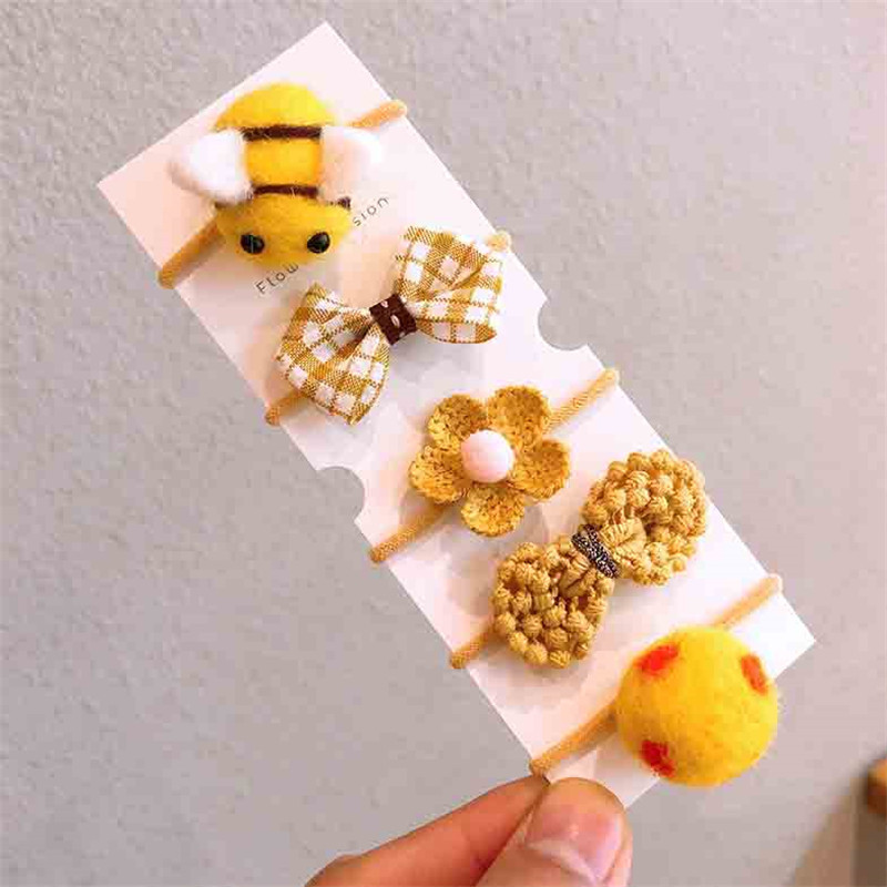 Őszi és téli új gyapjú filc öltöny Gyerek fejfedő Rajzfilm táska kis gumiszalag masni csomó haj kötél