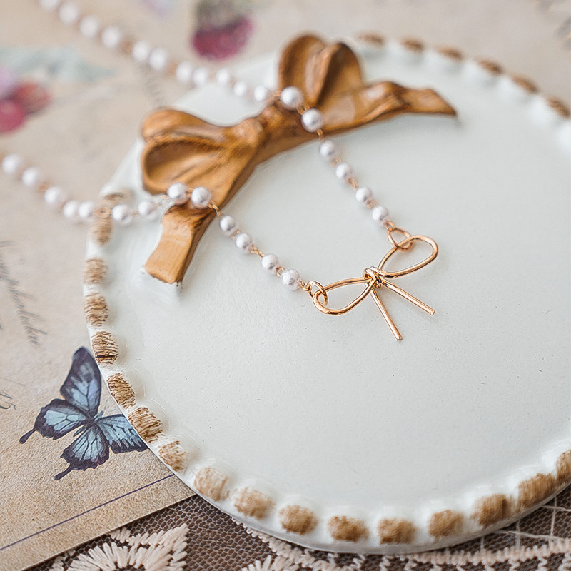 Starinski tanjur s mašnicom INS fotografija Snimanje mrtve prirode Foto studio Rekviziti za nakit Ogrlica Naušnice Fotografija