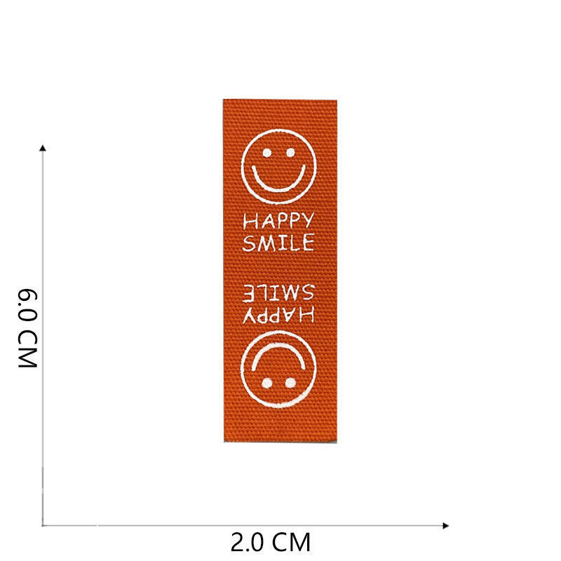 Naljepnice od tkanine Ručno izrađene naljepnice Preklopne oznake Uzorak osmijeha Ručno izrađene naljepnice za pletene kape Otisnute pamučno tkane šivane oznake 22120101