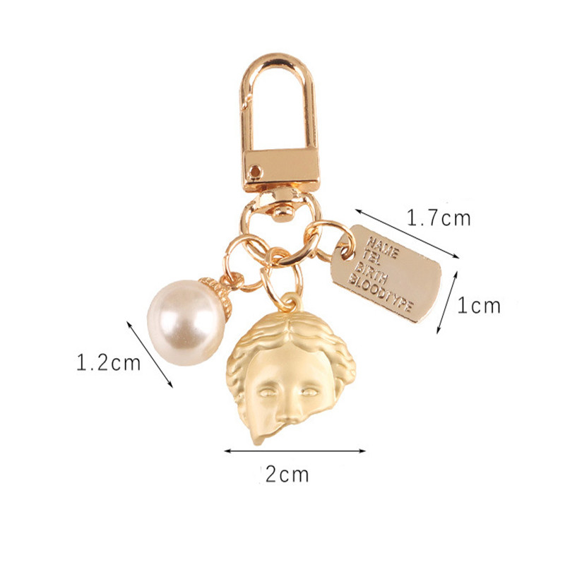 2 db táska medál Kreatív aranyos gyöngy félarcú ötvözet kulcstartó Divat autós kulcstartó kulcstartó medál táska bűbáj ékszer kiegészítők