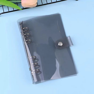 A7 izmēra caurspīdīgs, mīksts PVC 6 gredzenu iesiešanas piezīmjdatora vāks ar spiedpogas aizdari žurnālu plānotājam biroja kancelejas piederumiem