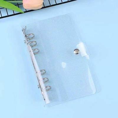 A7 izmēra caurspīdīgs, mīksts PVC 6 gredzenu iesiešanas piezīmjdatora vāks ar spiedpogas aizdari žurnālu plānotājam biroja kancelejas piederumiem