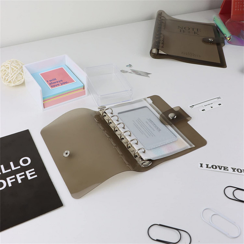 A7 izmēra caurspīdīgs, mīksts PVC 6 gredzenu iesiešanas piezīmjdatora vāks ar spiedpogas aizdari žurnālu plānotājam biroja kancelejas piederumiem