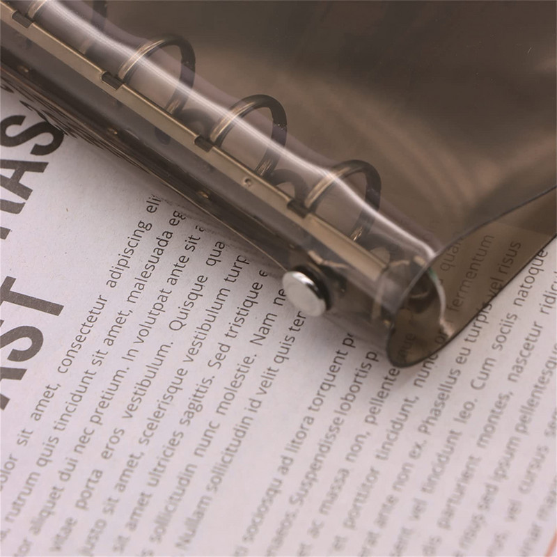 A7 izmēra caurspīdīgs, mīksts PVC 6 gredzenu iesiešanas piezīmjdatora vāks ar spiedpogas aizdari žurnālu plānotājam biroja kancelejas piederumiem