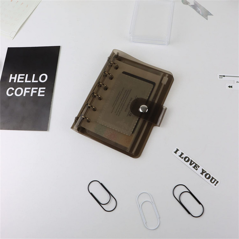 A7 izmēra caurspīdīgs, mīksts PVC 6 gredzenu iesiešanas piezīmjdatora vāks ar spiedpogas aizdari žurnālu plānotājam biroja kancelejas piederumiem