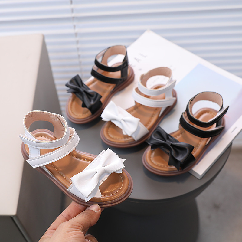 Sandale za malu djecu, remen za gležnjeve, mašne, crno-bijele klizače za djevojčice 21-30, fleksibilne ljetne dječje ravne cipele od pu kože za malu djecu