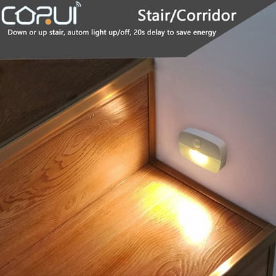 CORUI LED nakts automātiskās gaismas bezvadu PIR kustības sensors Mini gaiteņa skapis kāpņu istabas lampas ar baterijām darbināmas skapja durvju kāpnes