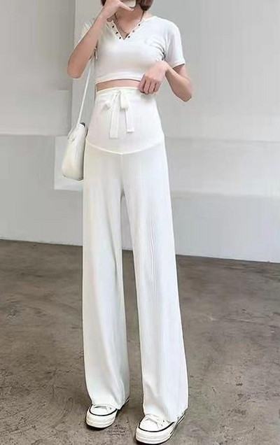 Pavasara jaunas, taisnas, modernas bikses, elpojošas plānas bikses grūtniecēm, valkājot brīvu ikdienas apģērbu