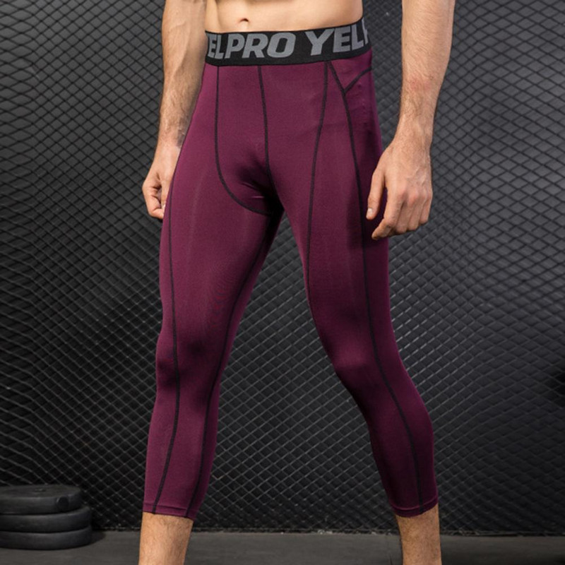 Meeste dressipüksid suure elastsusega Kiiresti kuivavad ergonoomika higineelduv polüester Fitness sääre keskosa pikkusega püksid.