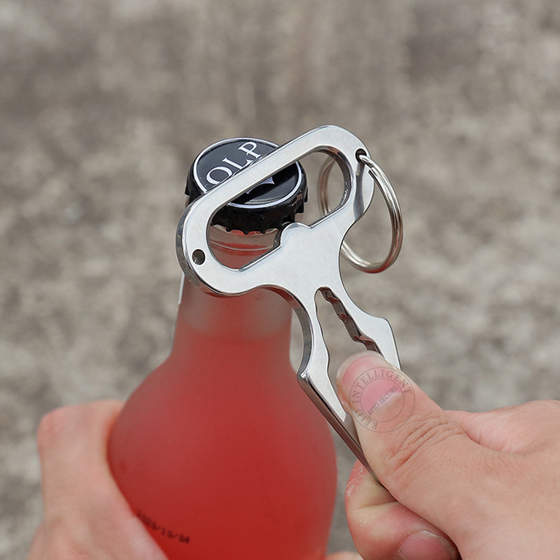 Nerūsējošā tērauda pašaizsardzības daudzrīku atslēgu piekariņš pudeļu attaisāmais skrūvgriezis āra kempinga aprīkojuma izdzīvošanas komplekts atslēgu piekariņš